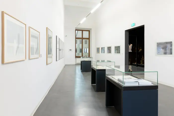 Eine Museumsansicht mit Bildern und Vitrinen 